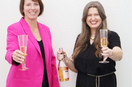 Two women with champagne saluting toward the viewer