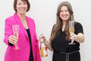 Two women with champagne saluting toward the viewer