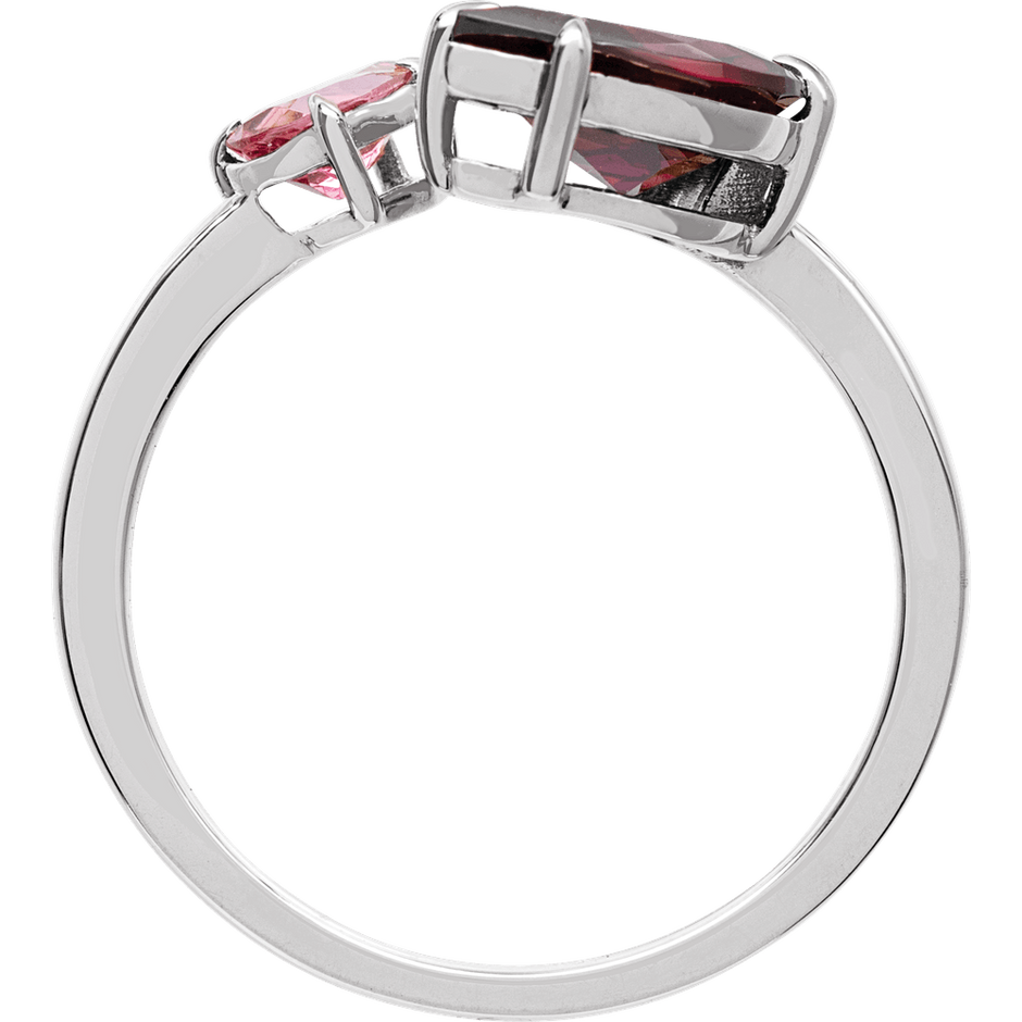 Silver ring with red gemstones on a white background