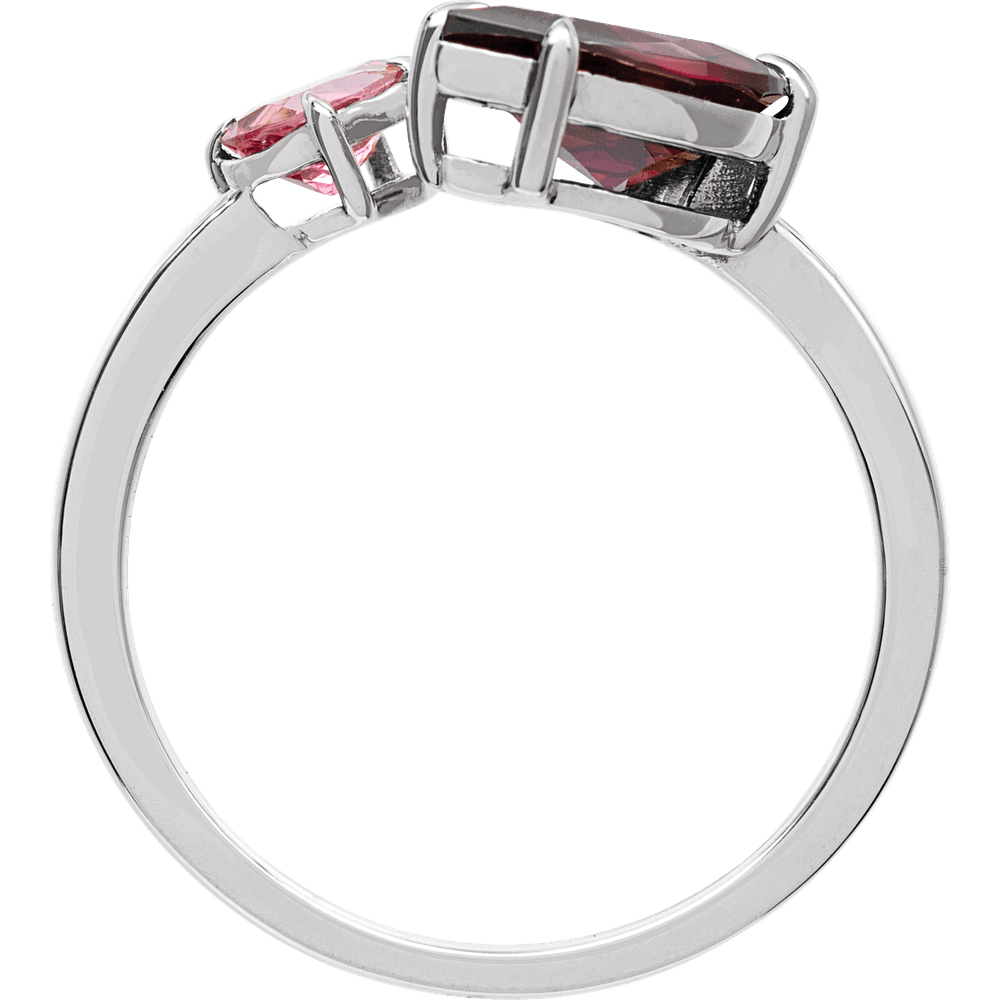 Silver ring with red gemstones on a white background