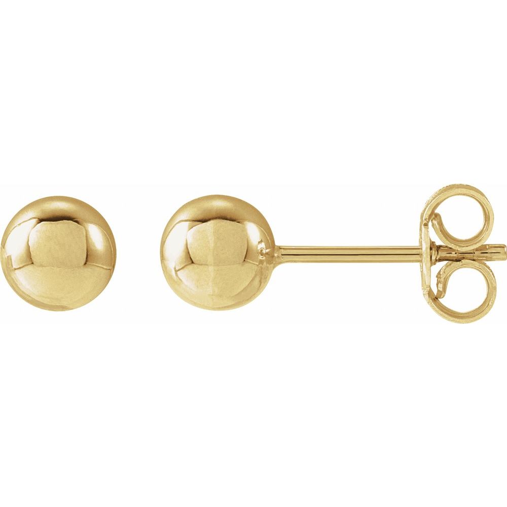 Gold ball earrings on a white background