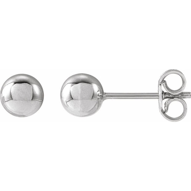 Pair of silver ball earrings on a white background