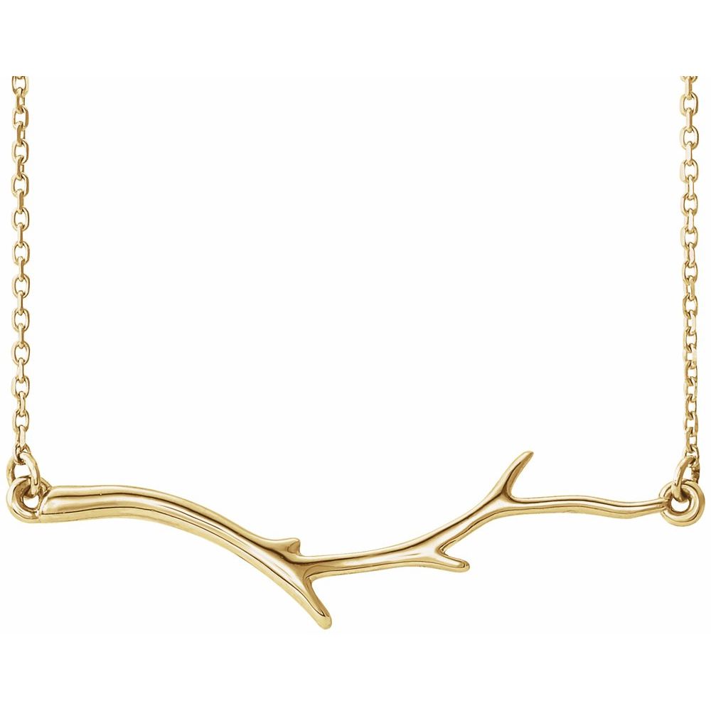 Gold branch-shaped necklace on a white background