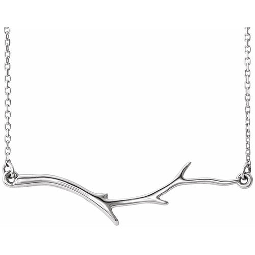 Silver branch-shaped necklace on a white background