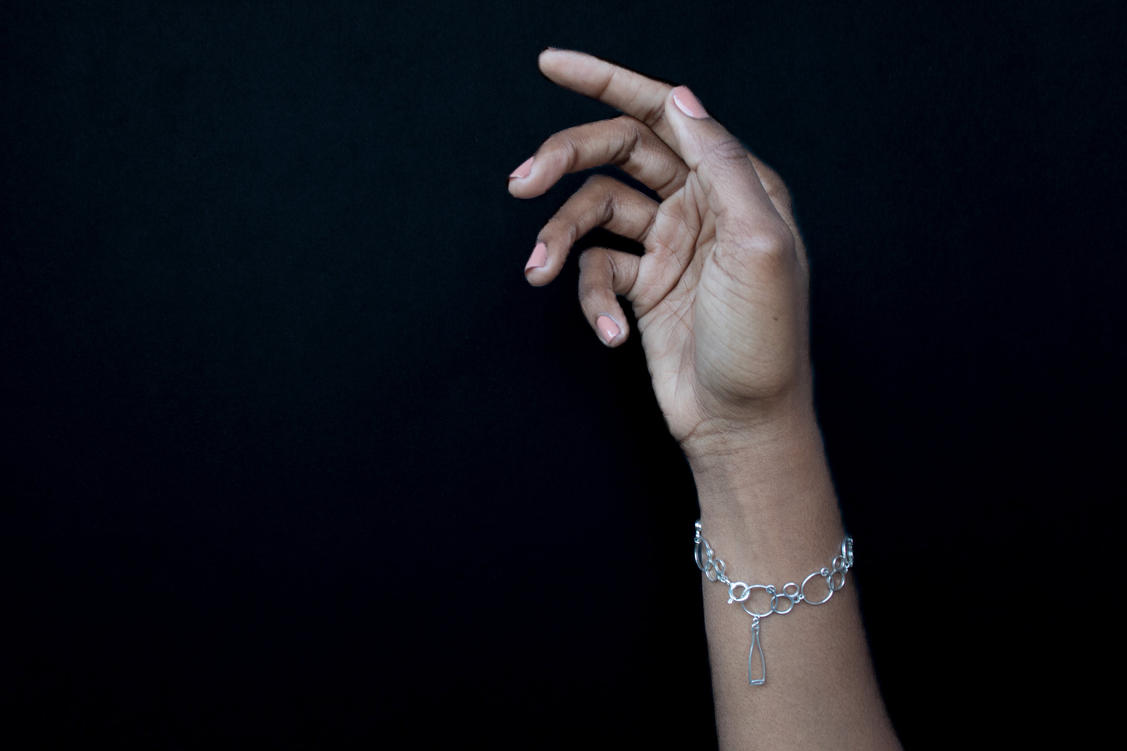 Silver Champagne bubble shaped charm bracelet on hand